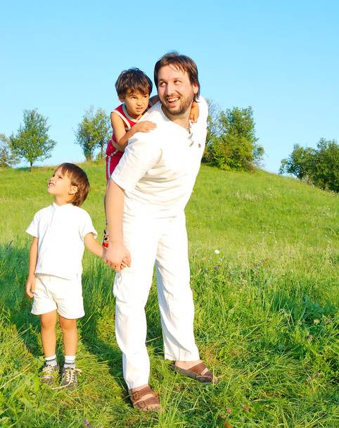 Young father in white with boys on beautiful meadow - Zdjęcie, obraz
