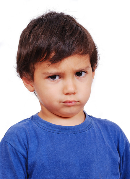 Cute kid with angry expression on his face - Zdjęcie, obraz