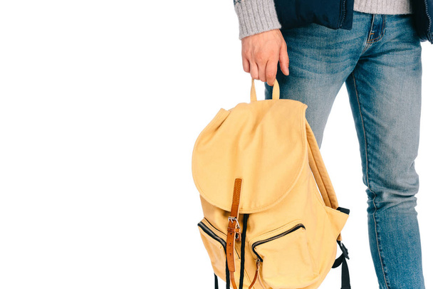 cropped shot of young traveler holding backpack isolated on white - Valokuva, kuva