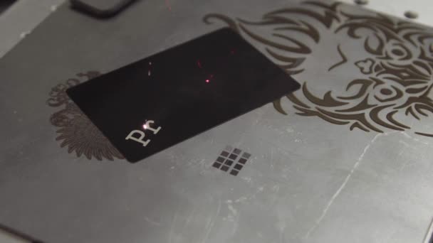Word Production being engraved with a laser from a metal material. Evident action of the laser at engraving of a souvenir overlay during an exhibition. Precision laser processing of the workpiece - Footage, Video