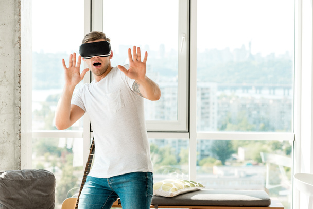 scared young man in vr headset at home - Photo, Image