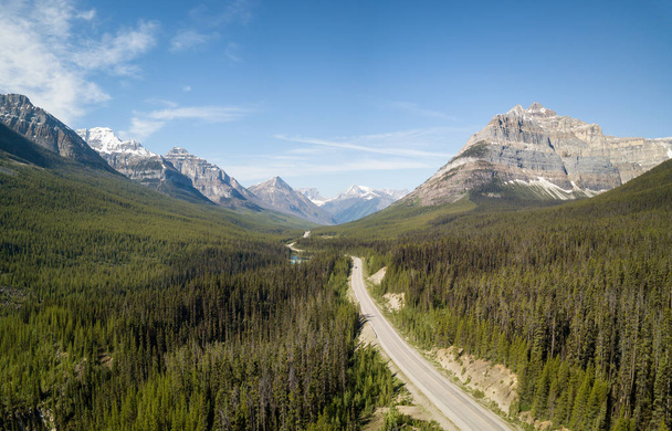 Aerial panoramic landscape view of a scenic road in the Canadian Rockies during a vibrant sunny summer day. Taken in Banff Windermere Parkway, Alberta, Canada. - Fotó, kép