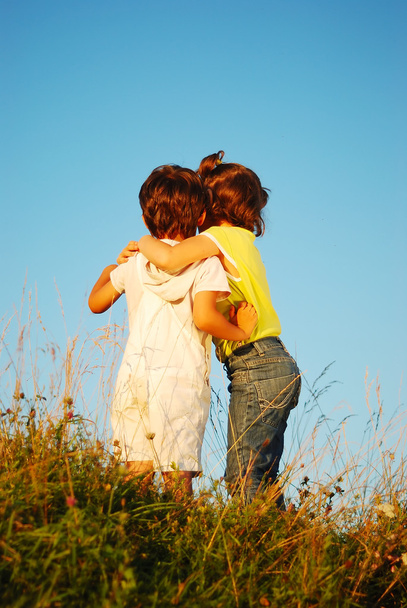 Romantic vision of two children standing together outdoor - Photo, Image