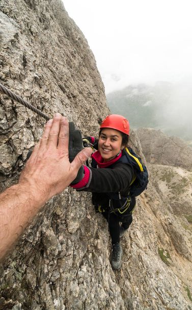 fiatal vonzó női hegymászó a giving neki útmutató egy ötöst a siker Dolomitok, Olaszország - Fotó, kép