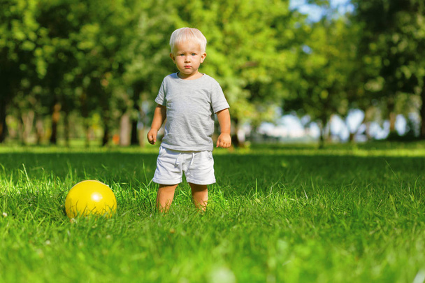 Calm kid playing with the ball outside - Φωτογραφία, εικόνα