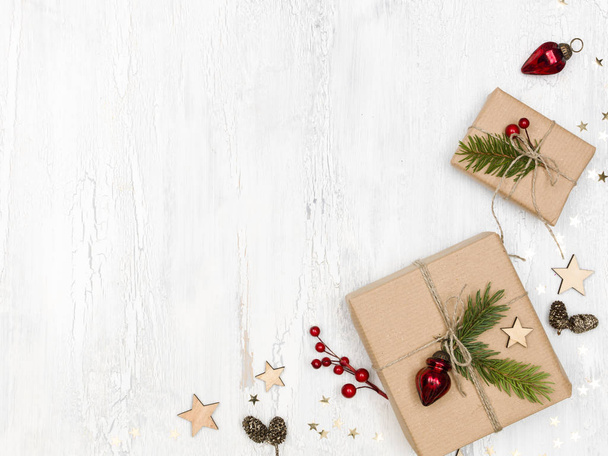 cardboard boxes with christmas decoration on white wooden background  - Fotografie, Obrázek