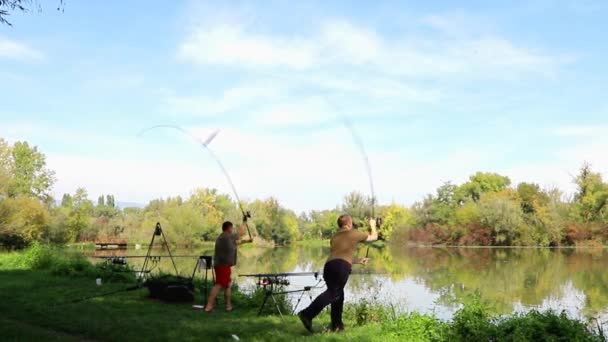 Two men synchronously carp fishing - Footage, Video