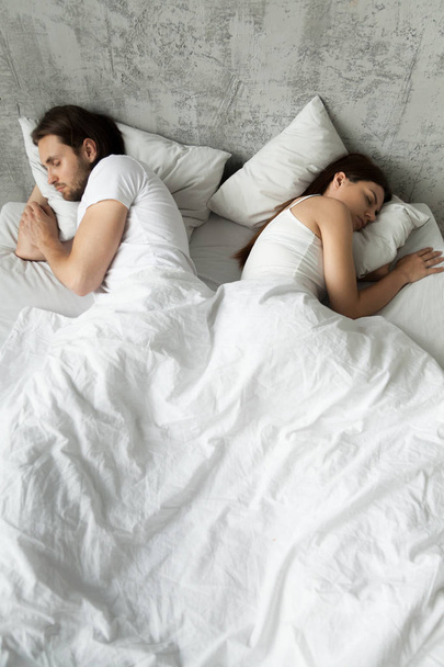 Indifferent couple sleep separately avoiding intimacy in bed - Фото, зображення