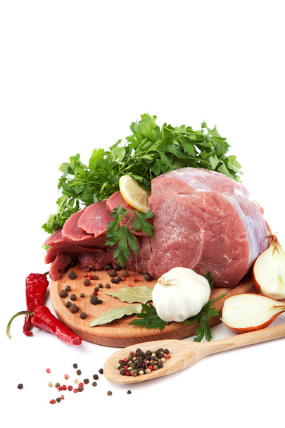 Raw meat, vegetables and spices on a wooden cutting board isolat - Photo, Image