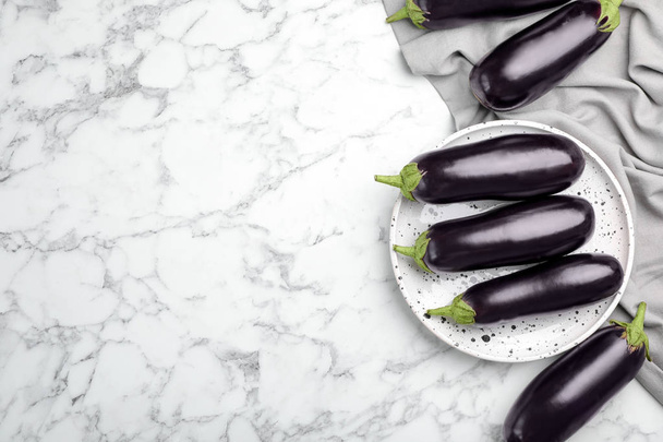 Raw ripe eggplants on marble background, top view - Φωτογραφία, εικόνα
