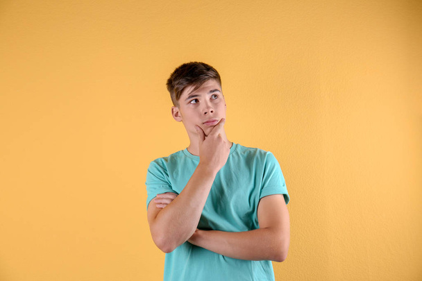 Teenage boy in casual clothes on color background - Фото, зображення