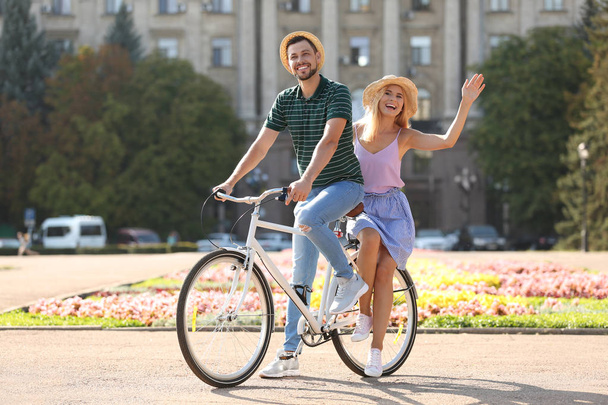Happy couple with bicycle outdoors on summer day - Foto, immagini