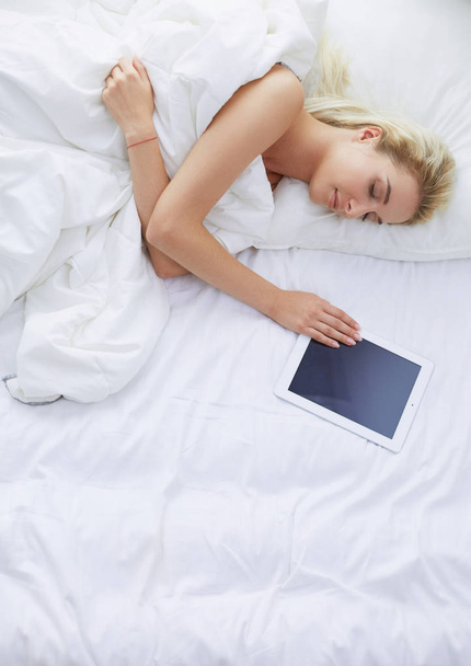 Girl holding digital tablet with blank screen and smiling at camera in bedroom - Fotografie, Obrázek