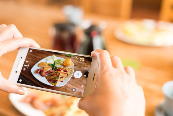 taking photo at morning breakfast on table - Photo, Image