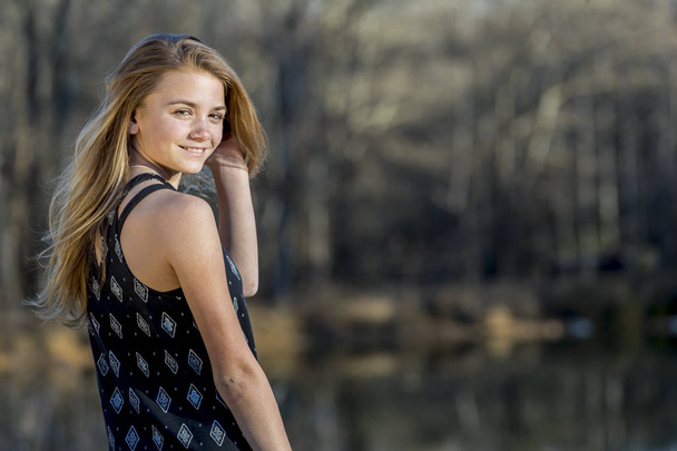 A beautiful young teenage blonde girl enjoying a beautiful day. - Photo, Image