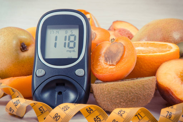 Glucose meter for checking sugar level, centimeter and fresh nutritious fruits as healthy dessert for diabetics - Fotografie, Obrázek