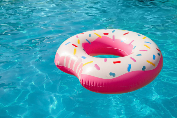 Inflatable ring floating in swimming pool on sunny day - Foto, Imagem