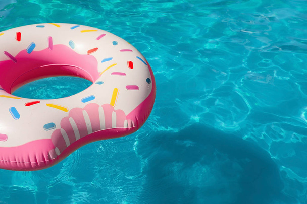 Inflatable ring floating in swimming pool on sunny day. Space for text - Fotografie, Obrázek