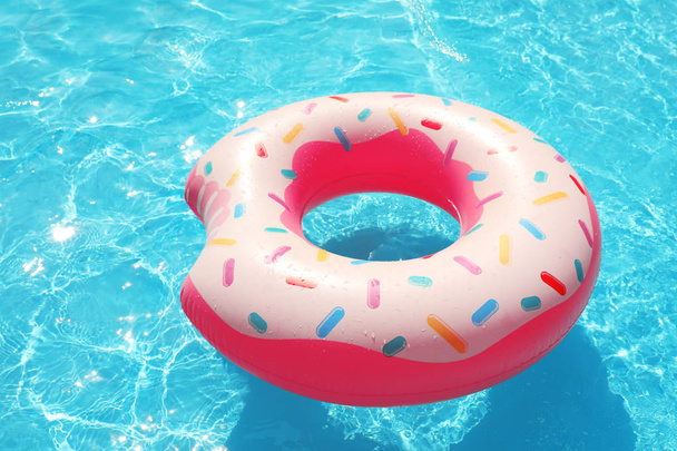 Inflatable ring floating in swimming pool on sunny day - Foto, Bild