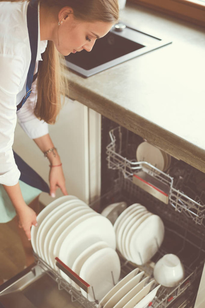 Dishwasher. Young woman in the Kitchen doing Housework. Wash-up - Fotoğraf, Görsel