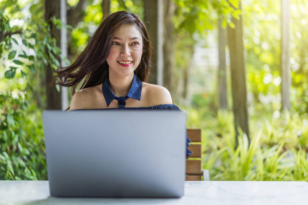 happy woman using laptop computer - 写真・画像