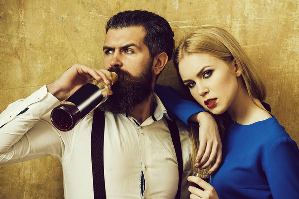 Hipster drinking wine from bottle and girl holding glass - Foto, imagen