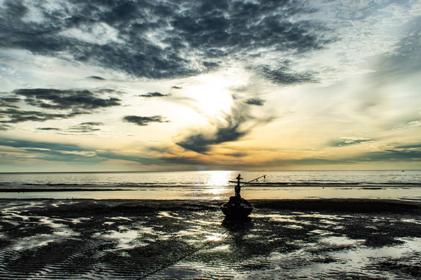 The morning sun light in the sea, and the boat on the beach. - Φωτογραφία, εικόνα