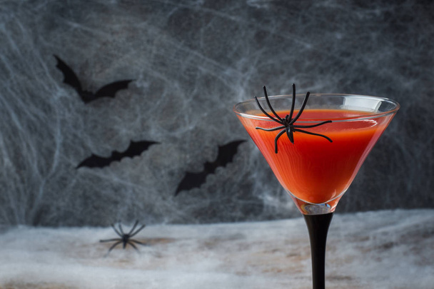 Bloody Mary cocktail, spider web background and bats for Halloween, selective focus. - Foto, Bild