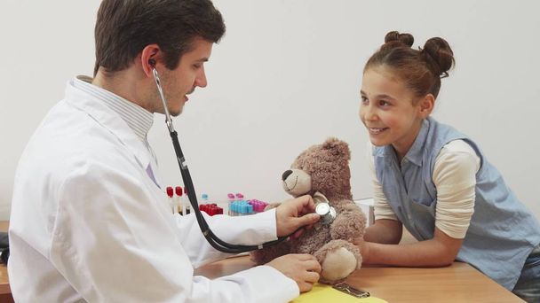 A little girl took her teddy bear to a doctors appointment. - Photo, Image