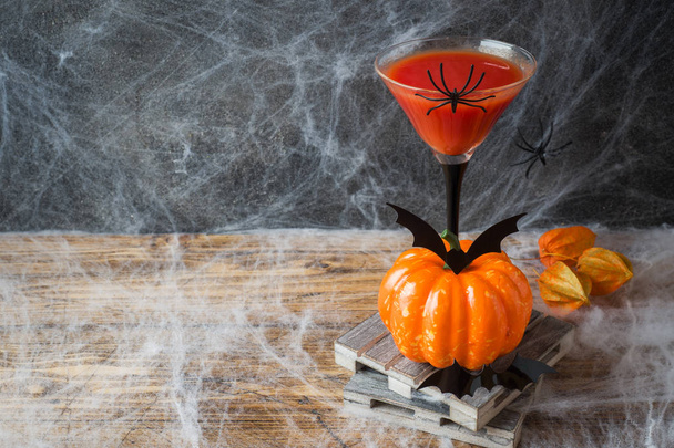 Bloody Mary cocktail, pumpkin with bats and spiders for Halloween, selective focus. Copy space - Фото, изображение