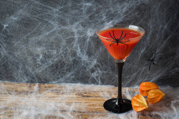 Bloody Mary cocktail, pumpkin with bats and spiders for Halloween, selective focus. Copy space - Фото, изображение