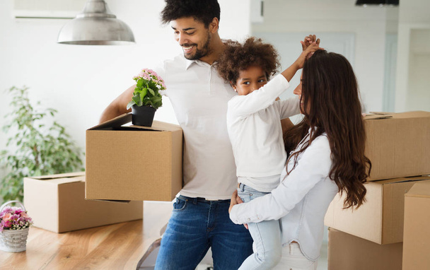 Happy family with cardboard boxes. Moving concept - Foto, imagen