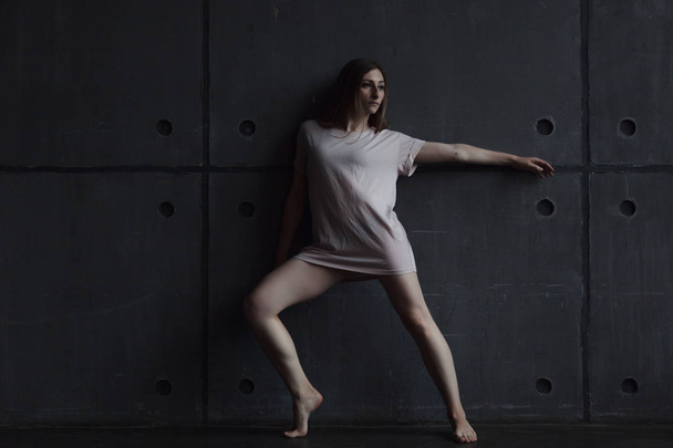 young beautiful woman professional dancer dancing during a rehearsal in a dance studio, modern dramatic style, experimental dance - Фото, зображення