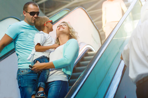 ターミナル空港のエスカレーターにカジュアルな服装で家族を愛する幸せ - 写真・画像
