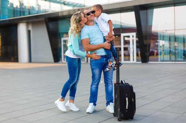 Happy family with luggage in airport ready to travel - Zdjęcie, obraz