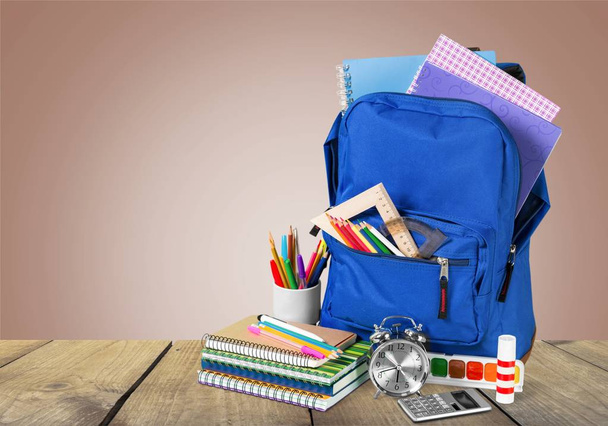 School Backpack with stationery on wooden table  - Φωτογραφία, εικόνα
