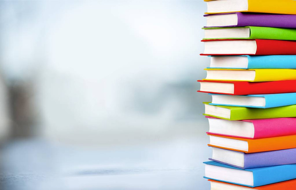 Stack of books in library on blurred background  - Foto, imagen
