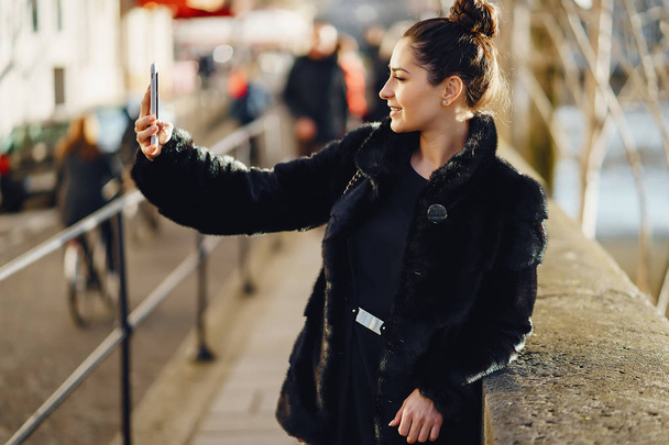 woman using her cell phone while walking through Paris - Φωτογραφία, εικόνα