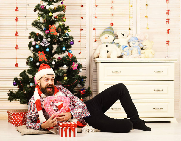 Santa Claus with happy face near bureau and Christmas tree - Zdjęcie, obraz