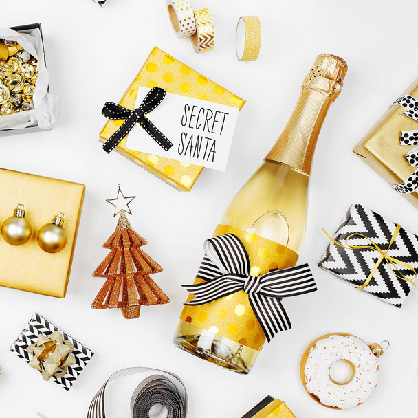 still life of golden Christmas decorations, gifts and champagne bottle - Φωτογραφία, εικόνα