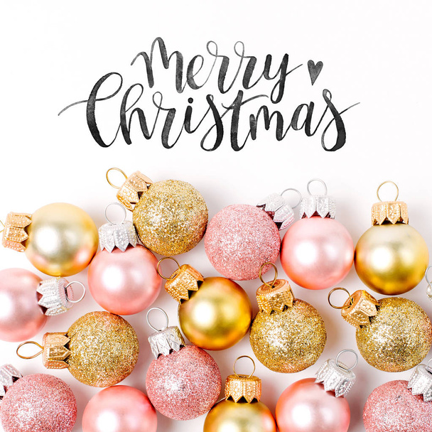 pink and golden christmas baubles with merry christmas lettering isolated on white background - Φωτογραφία, εικόνα