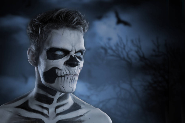 El cráneo constituye el retrato de un joven sobre el fondo del cielo nocturno. .. Zombies en Halloween
 - Foto, imagen