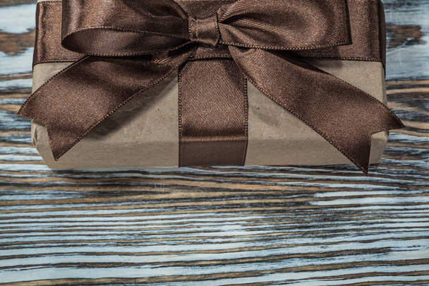 Brown gift box on wooden background. - 写真・画像