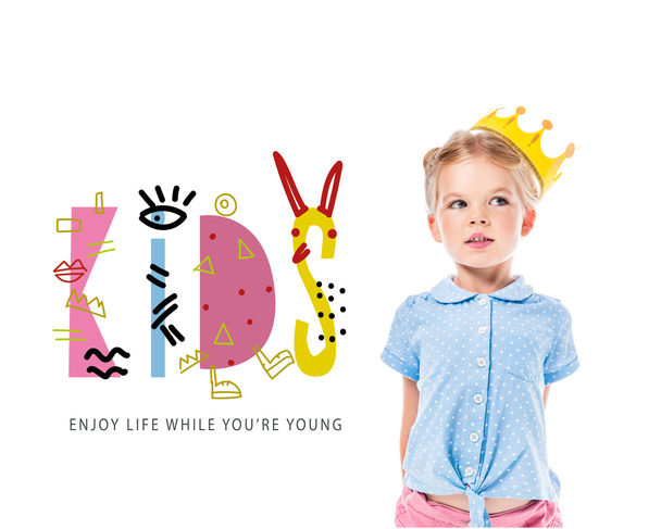 adorable pensive kid in yellow crown, isolated on white with "kids - enjoy life while you are young" inspiration - Φωτογραφία, εικόνα