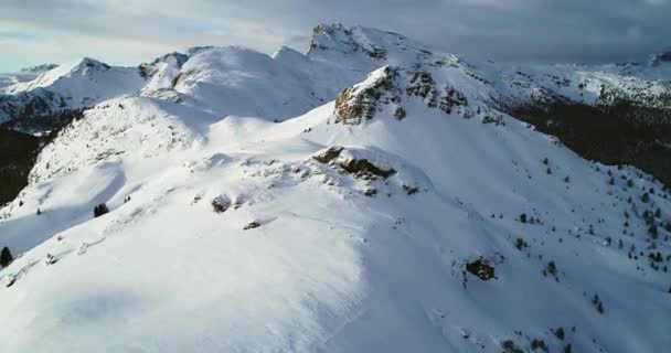 Forward aerial to snowy mount peaks at Valparola pass tilting up.Sunny sunset or sunrise, cloudy sky.Winter Dolomites Italian Alps mountains outdoor nature establisher.4k drone flight - Footage, Video