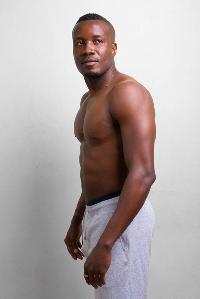 Young muscular African man shirtless against white background - Photo, Image