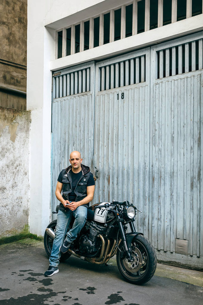 Biker posing with a motorcycle - Photo, Image