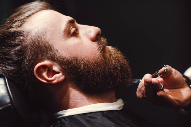 Barbershop concept. Beard model man and barber with scissors. - Photo, Image