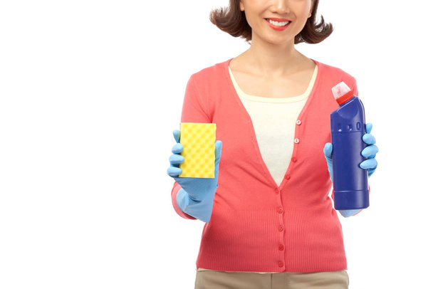 Cropped image of smiling housewife with detergent and sponge - Photo, Image