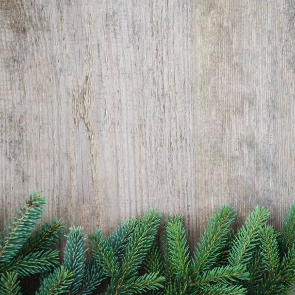 Spruce branches frame on old wooden table. Holiday concept. Copy space composition - 写真・画像